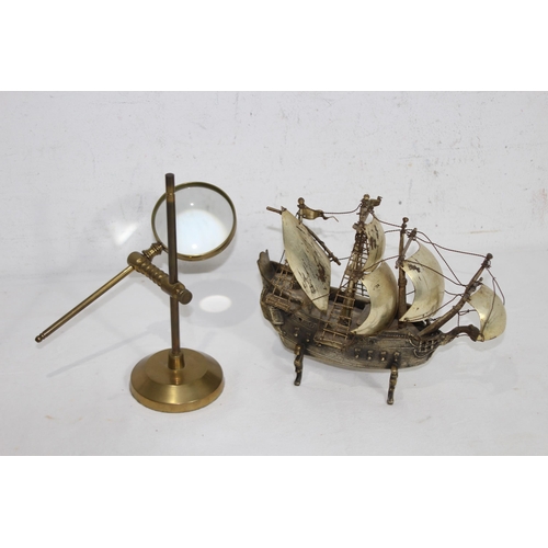 429 - METAL GALLEON AND BRASS MAGNIFYING GLASS
23 X 20CM