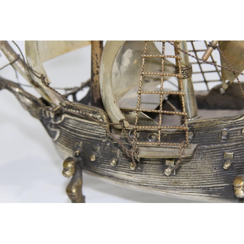 429 - METAL GALLEON AND BRASS MAGNIFYING GLASS
23 X 20CM