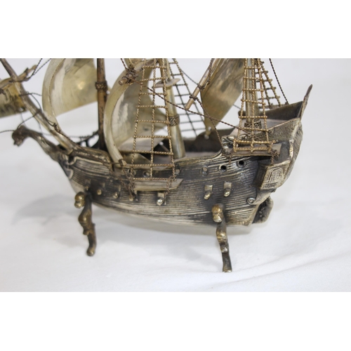 429 - METAL GALLEON AND BRASS MAGNIFYING GLASS
23 X 20CM