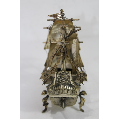 429 - METAL GALLEON AND BRASS MAGNIFYING GLASS
23 X 20CM