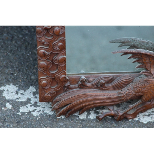 173 - VINTAGE EASTERN WOODEN CARVED MIRROR DEPICTING DRAGONS ETC 
65 X 46CM