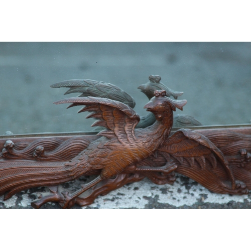 173 - VINTAGE EASTERN WOODEN CARVED MIRROR DEPICTING DRAGONS ETC 
65 X 46CM