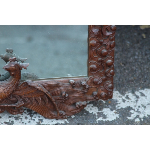 173 - VINTAGE EASTERN WOODEN CARVED MIRROR DEPICTING DRAGONS ETC 
65 X 46CM