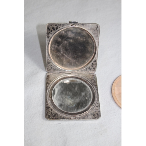 1099 - SILVER COMPACT OF OCTAGONAL FORM - BIRMINGHAM 1951 AND A FLORAL DECORATED WHITE METAL COMPACT