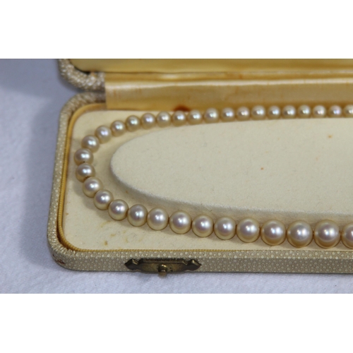 1182 - 2 X 9CT GOLD CLASPED GRADUATED FAUX PEARL NECKLACES, ONE CASED AND RETAILED BY CIRO OF BOND STREET