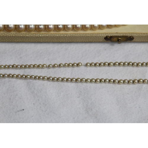 1182 - 2 X 9CT GOLD CLASPED GRADUATED FAUX PEARL NECKLACES, ONE CASED AND RETAILED BY CIRO OF BOND STREET