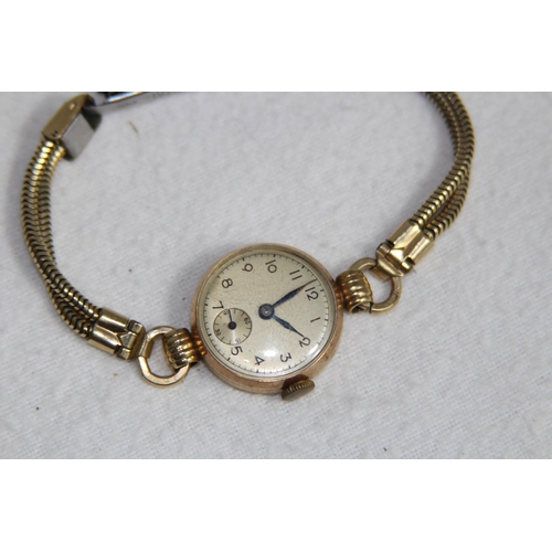 1190 - 9CT GOLD CASED WATCH ON A ROLLED GOLD BRACELET - TOTAL WEIGHT 18G