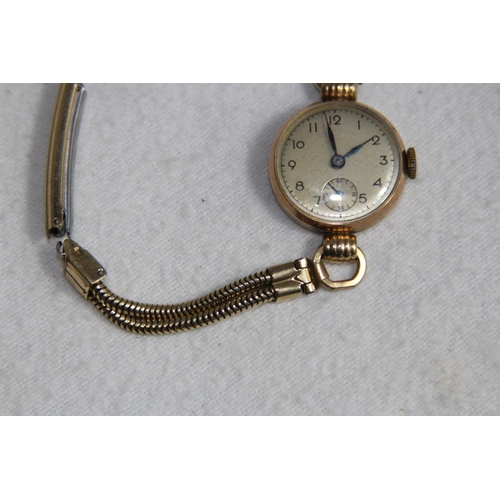 1190 - 9CT GOLD CASED WATCH ON A ROLLED GOLD BRACELET - TOTAL WEIGHT 18G