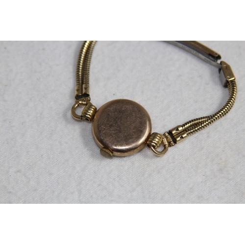 1190 - 9CT GOLD CASED WATCH ON A ROLLED GOLD BRACELET - TOTAL WEIGHT 18G