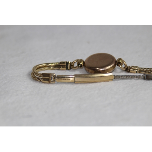 1190 - 9CT GOLD CASED WATCH ON A ROLLED GOLD BRACELET - TOTAL WEIGHT 18G