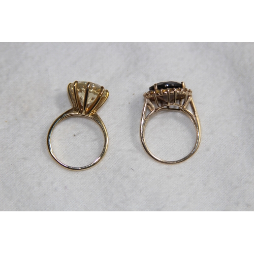 1210 - TWO 9CT GOLD RINGS WITH DIFFERENT STONES - 7.55G - SIZE 0 1/2