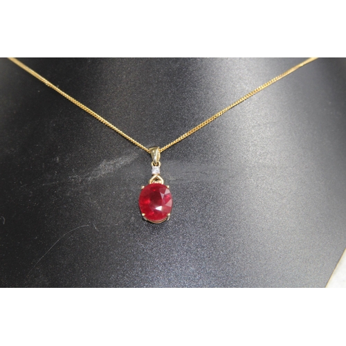 1220 - LARGE RUBY AND DIAMOND 9CT GOLD NECKLANE - 5.25G - BOXED