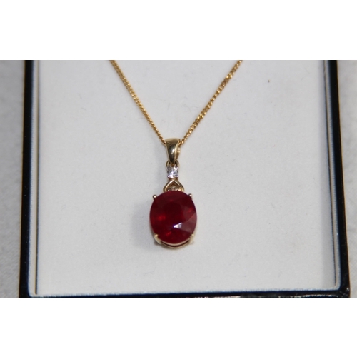 1220 - LARGE RUBY AND DIAMOND 9CT GOLD NECKLANE - 5.25G - BOXED