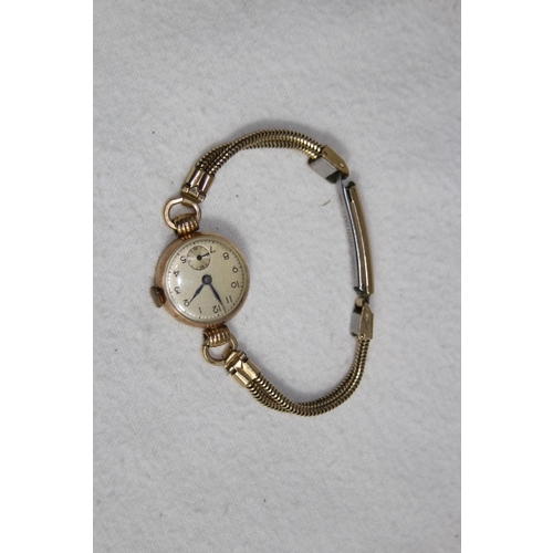 1190 - 9CT GOLD CASED WATCH ON A ROLLED GOLD BRACELET - TOTAL WEIGHT 18G