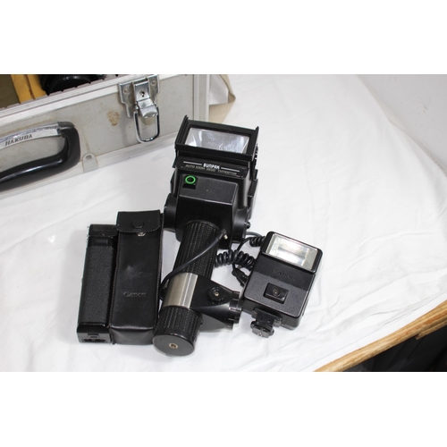 722 - QUANTITY OF CASED CAMERA EQUIPMENT INCLUDING CANON CAMERA AND VARIOUS LENSES ETC
