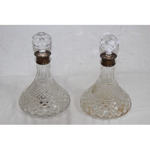 1071 - PAIR OF SILVER COLLARED DECANTERS