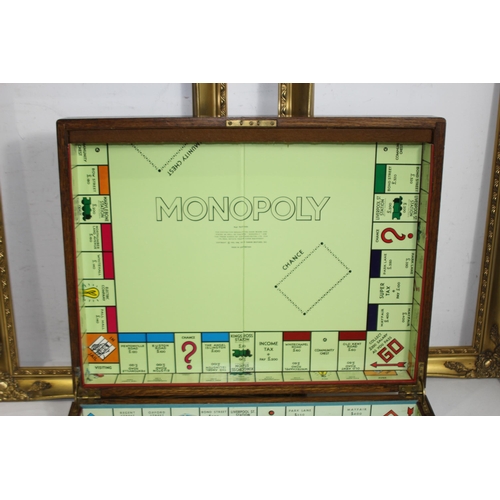 384 - VINTAGE WOODEN CUTLERY BOX WITH A MONOPOLY BOARD PLUS TWO WOODEN FRAMES 
60 X 49CM