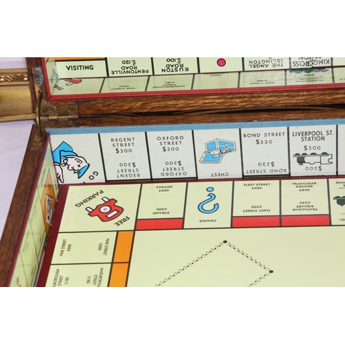 384 - VINTAGE WOODEN CUTLERY BOX WITH A MONOPOLY BOARD PLUS TWO WOODEN FRAMES 
60 X 49CM