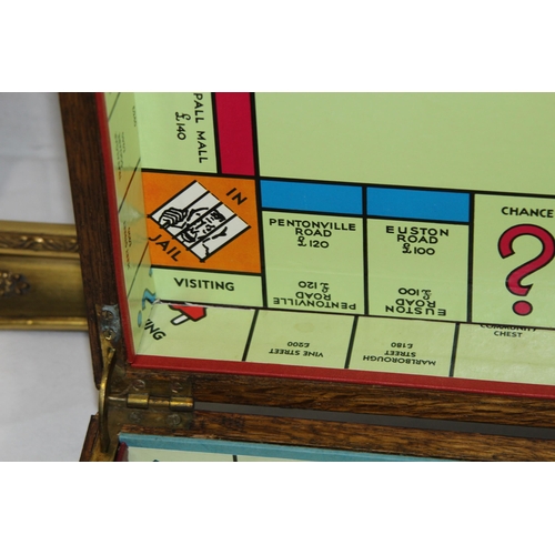 384 - VINTAGE WOODEN CUTLERY BOX WITH A MONOPOLY BOARD PLUS TWO WOODEN FRAMES 
60 X 49CM