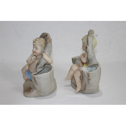 340 - PAIR OF BISQUE POSY HOLDERS DEPICTING CHERUBS
17 X 15CM