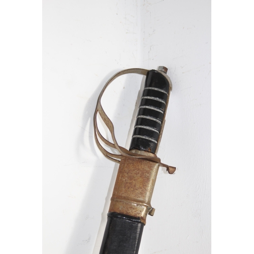 909 - INDIAN FORGED CURVED SWORD IN SCABBARD WITH ETCHED BLADE