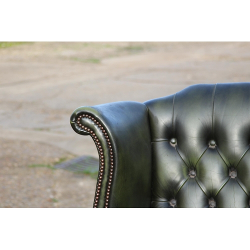 108 - GREEN LEATHER  CHESTERFIELD WINGBACK ARMCHAIR AND FOOTSTOOL
93 X 80 X 106CM