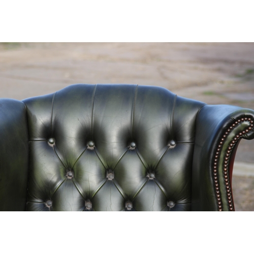 108 - GREEN LEATHER  CHESTERFIELD WINGBACK ARMCHAIR AND FOOTSTOOL
93 X 80 X 106CM