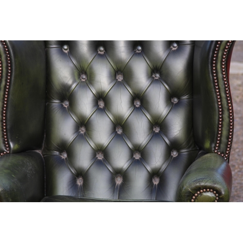 108 - GREEN LEATHER  CHESTERFIELD WINGBACK ARMCHAIR AND FOOTSTOOL
93 X 80 X 106CM