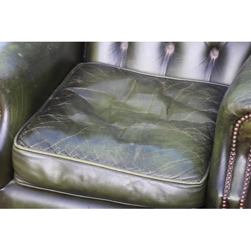 108 - GREEN LEATHER  CHESTERFIELD WINGBACK ARMCHAIR AND FOOTSTOOL
93 X 80 X 106CM