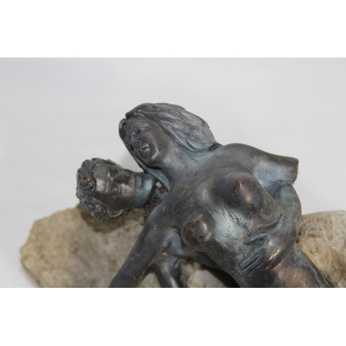 748 - PERIOD ART DECO MODEL OF A COUPLE IN AN EMBRACE WITH A ROCK BACKGROUND, 11 INCHES TALL, BASE DETERIO... 