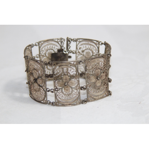 863 - MIDDLE EASTERN SILVER FILIGREE PANELLED BRACELET, 26.11 GRAMS
