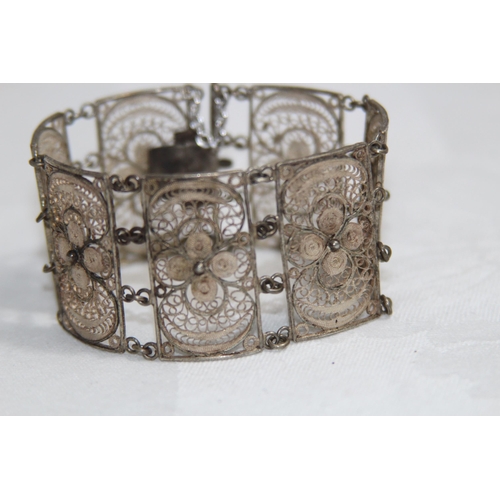 863 - MIDDLE EASTERN SILVER FILIGREE PANELLED BRACELET, 26.11 GRAMS