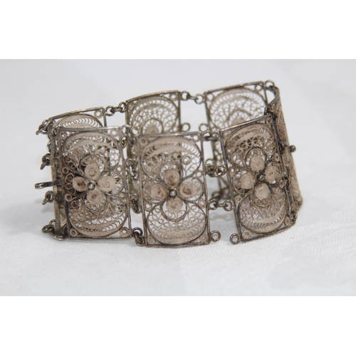 863 - MIDDLE EASTERN SILVER FILIGREE PANELLED BRACELET, 26.11 GRAMS