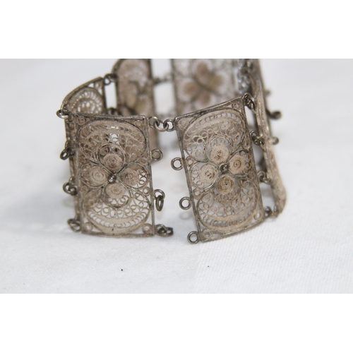 863 - MIDDLE EASTERN SILVER FILIGREE PANELLED BRACELET, 26.11 GRAMS