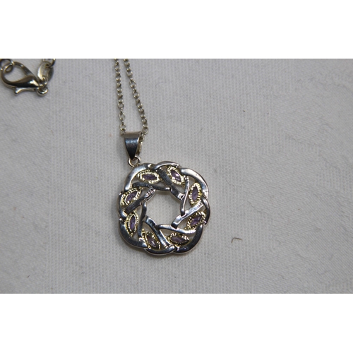 871 - CELTIC DESIGN PENDANT NECKLACE SET WITH AMETHYST COLOURED STONES