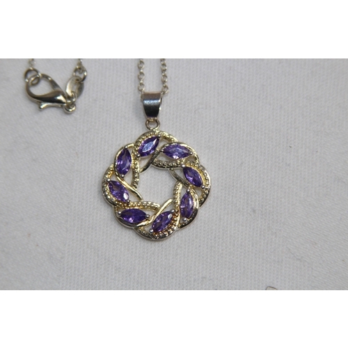 871 - CELTIC DESIGN PENDANT NECKLACE SET WITH AMETHYST COLOURED STONES