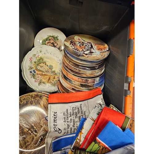 332 - Two Boxes Of Decorative Plates And Vintage Tea Towels.