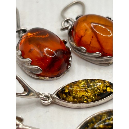 267 - Two Pairs Of Silver And Amber Earrings.