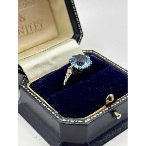 903 - Nice Looking Silver Ring With Blue Stone And Decorated Shoulders.