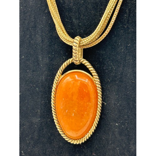 265 - Vintage Monet Yellow Metal Chain And Orange Polished Stone Pendant.