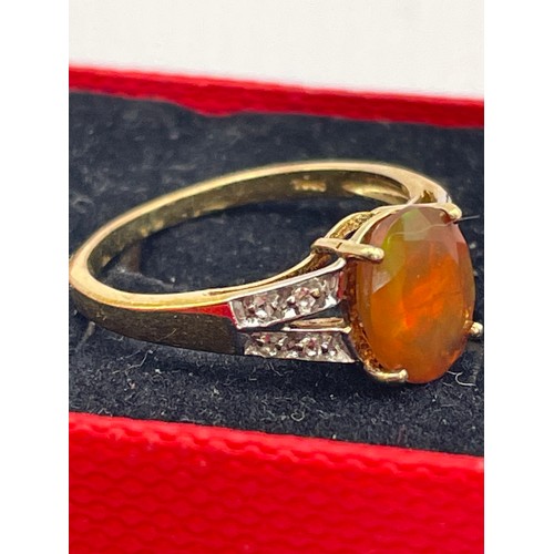 255 - Silver , Gold Coloured Ring With Orange Oval Stone.