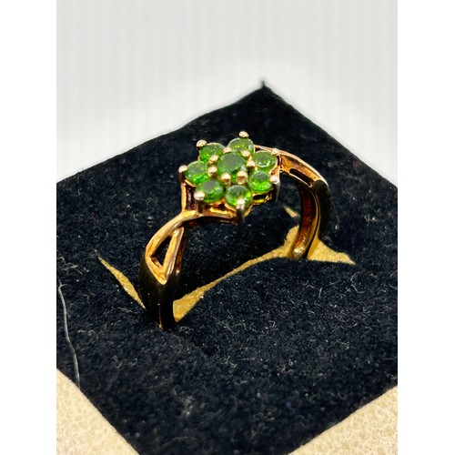 356 - Silver , Gold Coloured Ring With Seven Green Stones As A Flower.