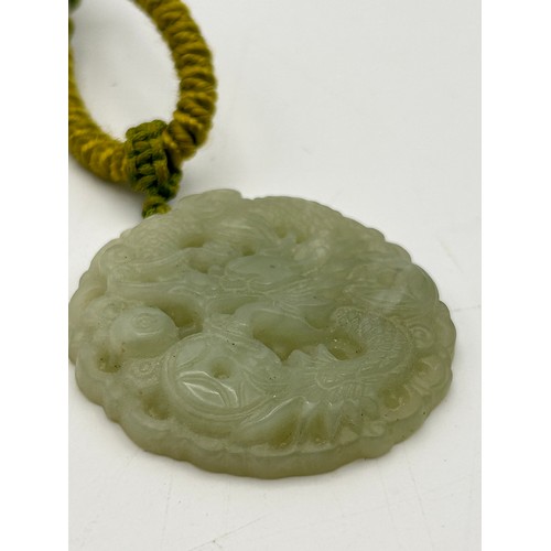 70 - Nicely Carved Round Jade Pendant , 2