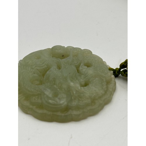 70 - Nicely Carved Round Jade Pendant , 2