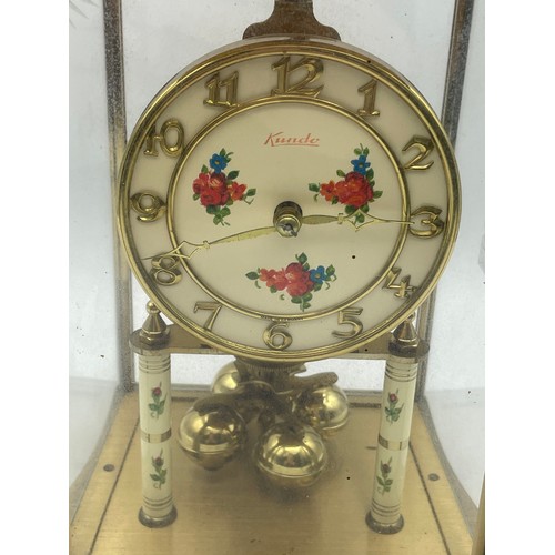 54 - Brass Kundo Clock With Floral Detail , 9.5.” X 5”.