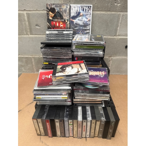 A Collection of Compact Discs, Cassette Tapes, and DVDs/Blu-rays