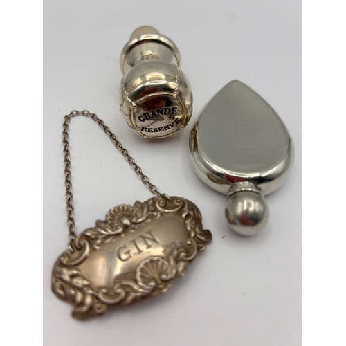 100 - A Trio of Accessories , Silver Gin Label , Stopper , Small Flask.