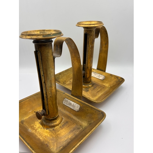 105 - A Pair of English Brass Ejector Chambersticks, Dated 1912