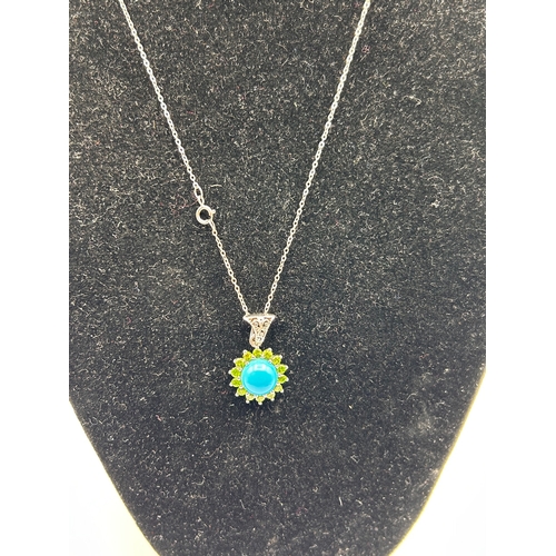 63 - A Silver Turquoise and Peridot Sunburst Pendant Necklace