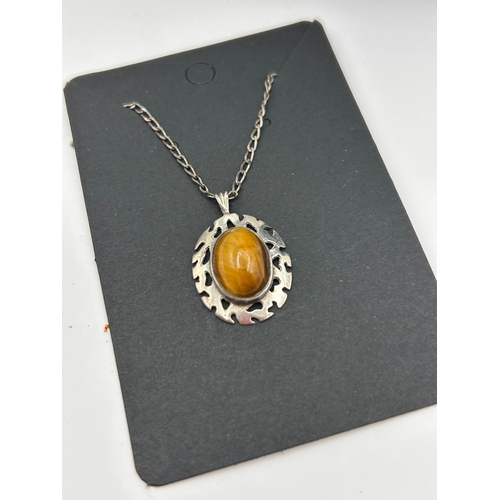 67 - A Silver Necklace with Tiger's Eye Cabochon Pendant